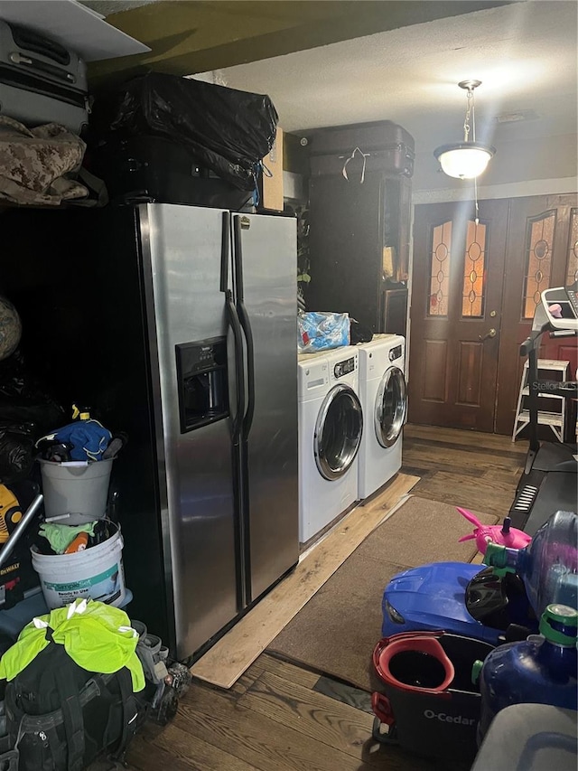 laundry room featuring washing machine and clothes dryer and hardwood / wood-style flooring