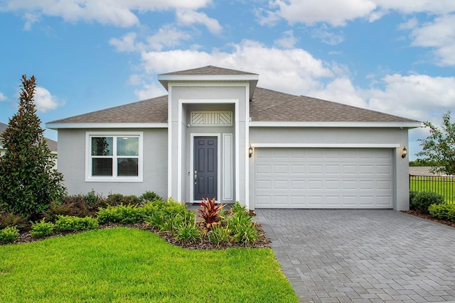 view of front facade with a front lawn and a garage