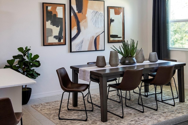 dining room with tile patterned flooring and baseboards