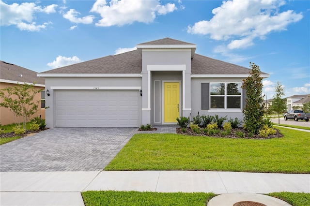 1343 Foran Manor Rd, Haines City, FL 33844 - view of front of property with driveway, stucco siding, an attached garage, a shingled roof, and a front lawn