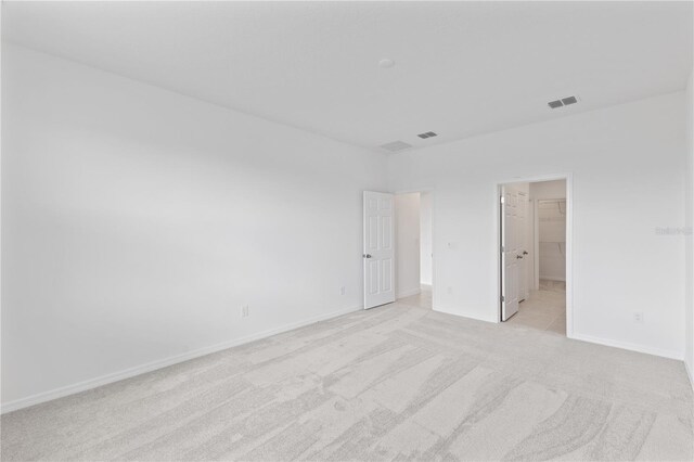 1343 Foran Manor Rd, Haines City, FL 33844 - unfurnished bedroom with light carpet and a spacious closet
