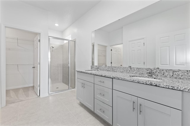 1343 Foran Manor Rd, Haines City, FL 33844 - full bath with double vanity, a shower stall, a spacious closet, tile patterned flooring, and recessed lighting