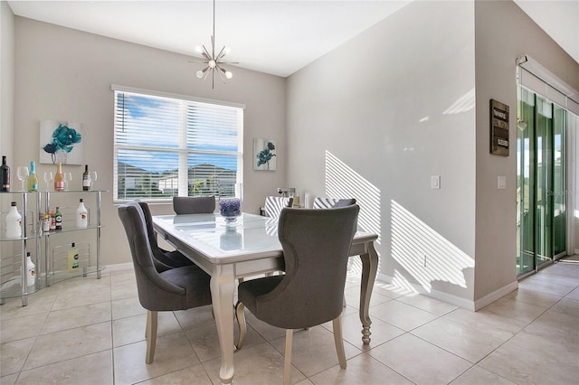 dining area with light tile patterned floors and a notable chandelier