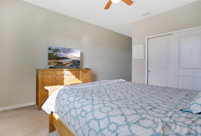 carpeted bedroom featuring a closet and ceiling fan