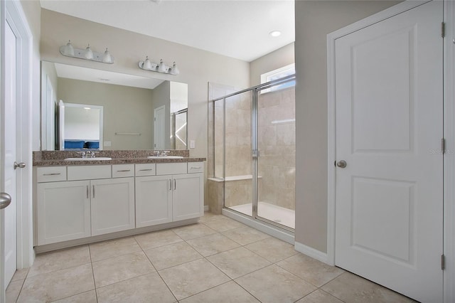 bathroom with tile patterned flooring, an enclosed shower, and vanity