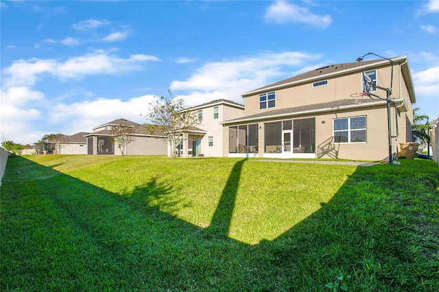 rear view of property featuring a yard and a sunroom