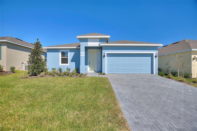 view of front facade with a garage and a front yard