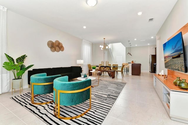 living room with a chandelier and light tile patterned floors