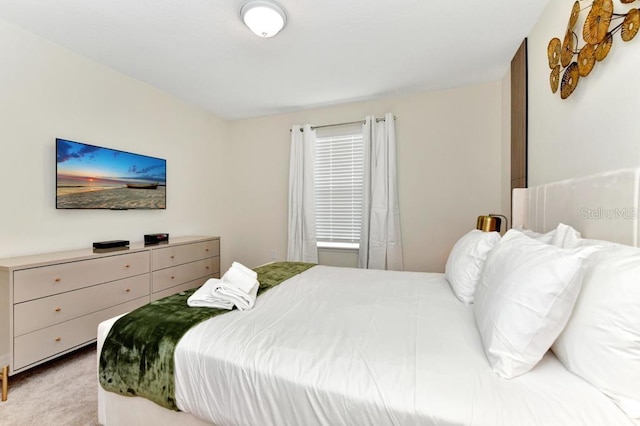 bedroom featuring light carpet