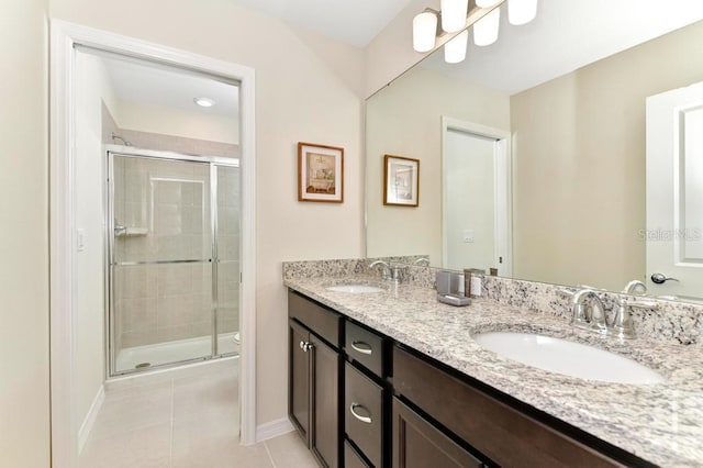 bathroom with tile patterned floors, vanity, and an enclosed shower