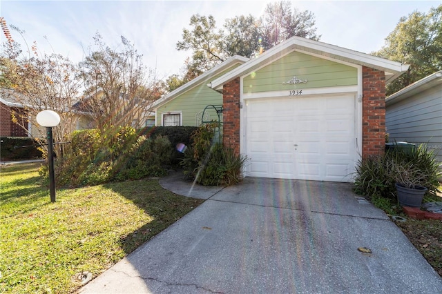 exterior space featuring a lawn, an outbuilding, and a garage