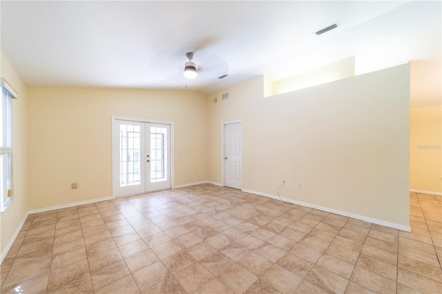 tiled empty room with ceiling fan and french doors