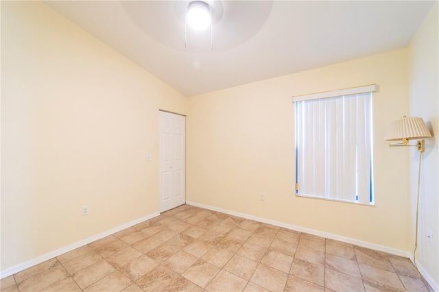 spare room featuring lofted ceiling