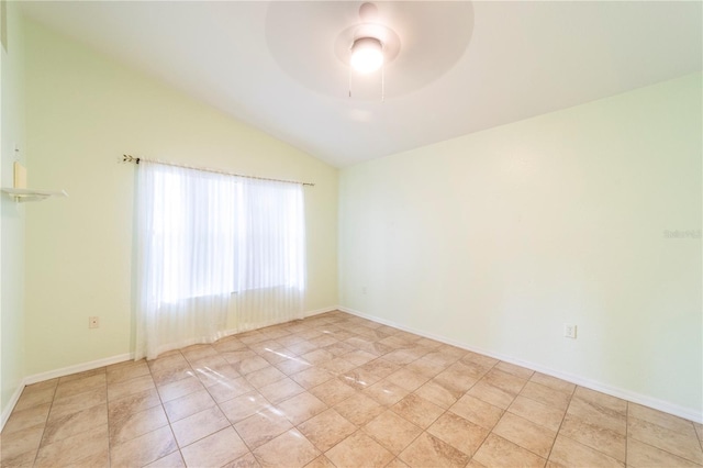 spare room with ceiling fan, light tile patterned floors, and lofted ceiling