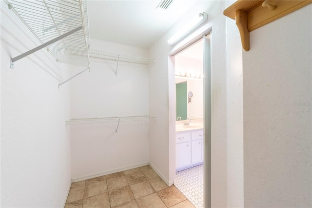 walk in closet featuring sink