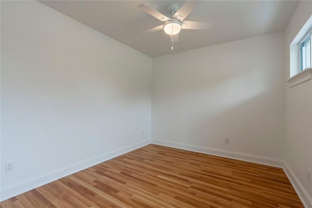 spare room with hardwood / wood-style floors and ceiling fan