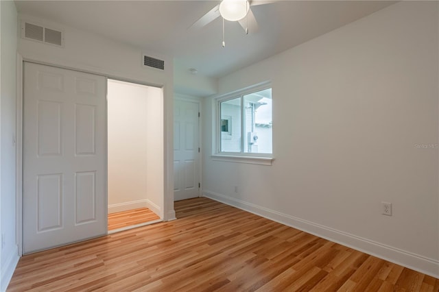 unfurnished bedroom with ceiling fan, light hardwood / wood-style floors, and a closet