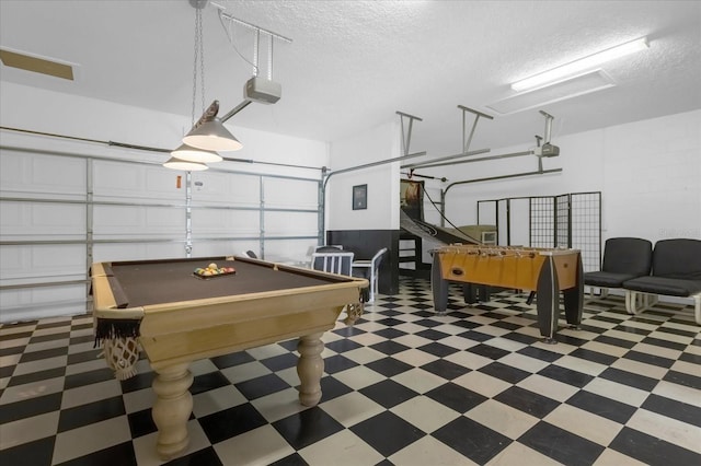 recreation room featuring pool table and a textured ceiling