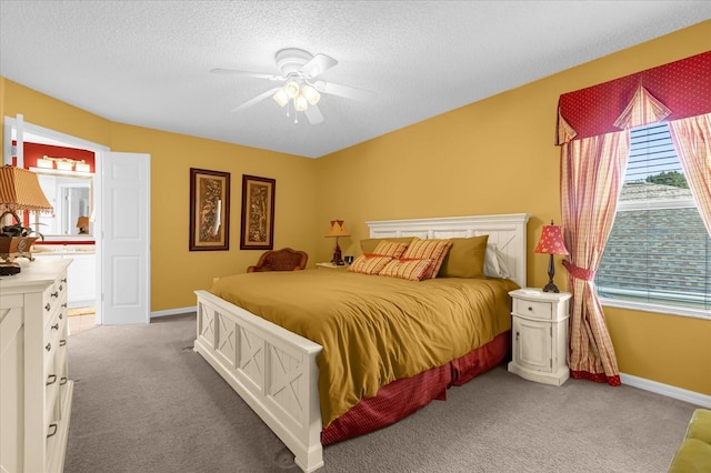 carpeted bedroom with ceiling fan and a textured ceiling