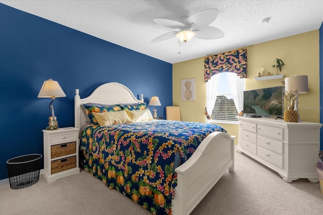 carpeted bedroom with ceiling fan and a textured ceiling