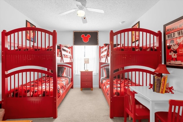 bedroom featuring ceiling fan, a textured ceiling, and carpet flooring