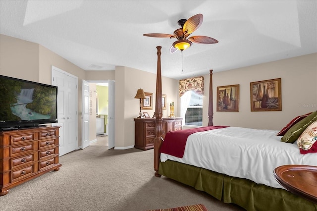 carpeted bedroom with connected bathroom, a tray ceiling, a textured ceiling, and ceiling fan