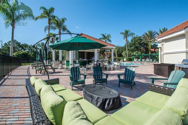 view of patio / terrace featuring area for grilling, a fenced in pool, and outdoor lounge area