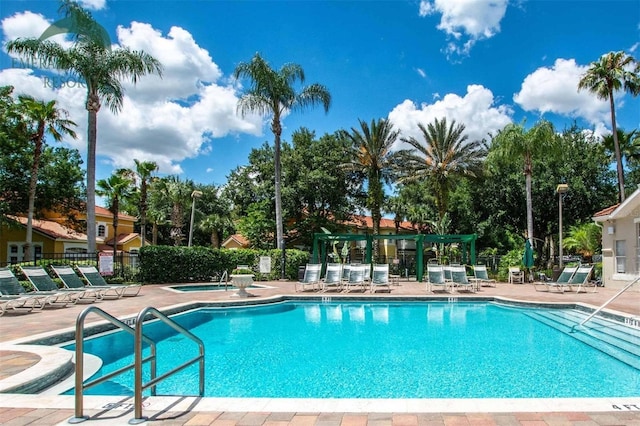 view of pool with a community hot tub and a patio area