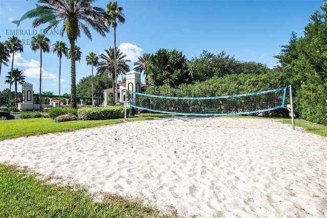 view of property's community featuring volleyball court and a lawn