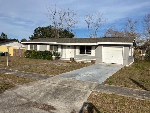 ranch-style home with a garage and a front yard