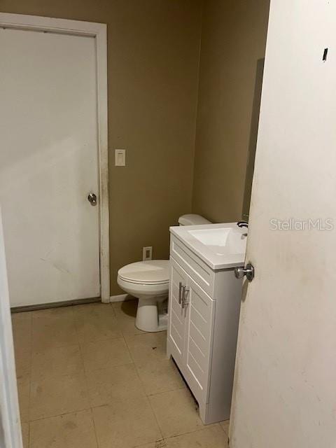 bathroom featuring toilet and vanity