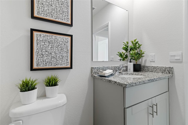 bathroom featuring toilet and vanity