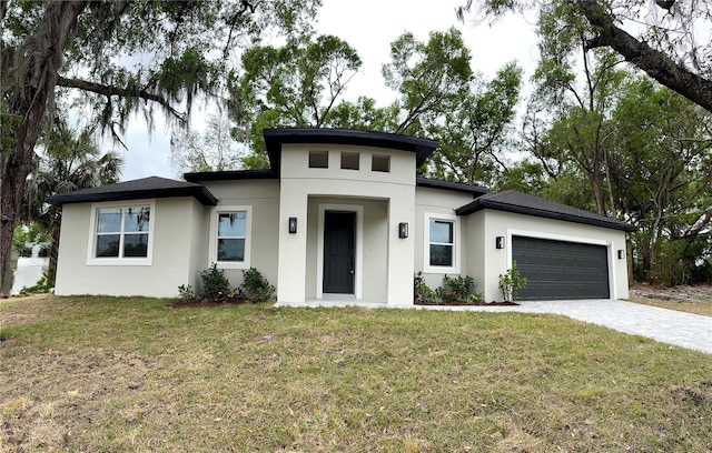 116 E Cleveland St, Apopka, FL 32703 - prairie-style house with stucco siding, a garage, a front lawn, and decorative driveway