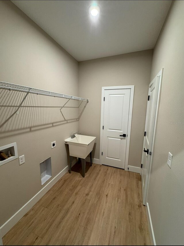 116 E Cleveland St, Apopka, FL 32703 - washroom with washer hookup, hookup for an electric dryer, laundry area, baseboards, and light wood-style floors