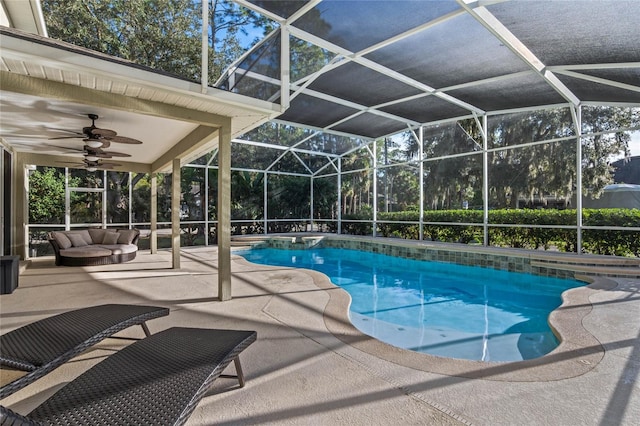 pool with a lanai, a patio area, and a ceiling fan