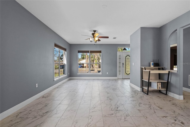 living room with marble finish floor, ceiling fan, and baseboards