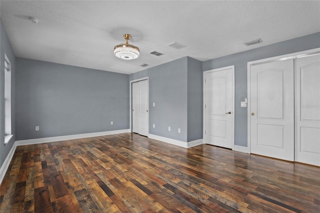 interior space with visible vents, baseboards, and wood finished floors