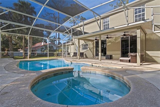 view of swimming pool featuring a lanai, ceiling fan, a pool with connected hot tub, and a patio