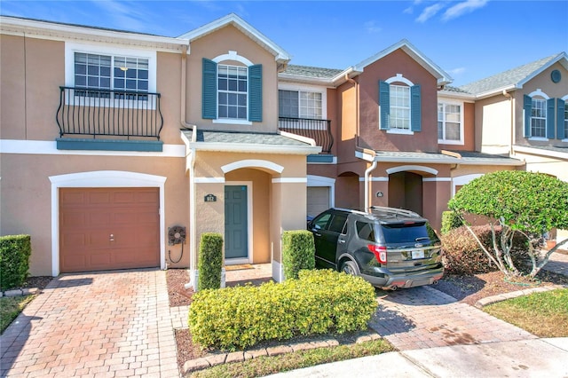 view of property featuring a balcony and a garage