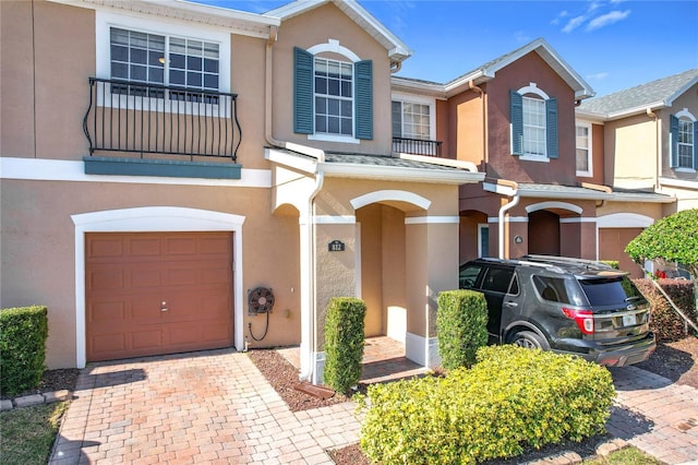 multi unit property with a garage and a balcony