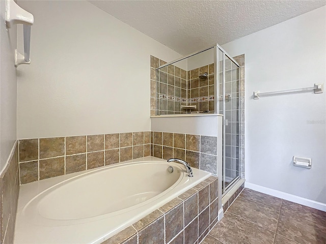 bathroom featuring independent shower and bath and a textured ceiling