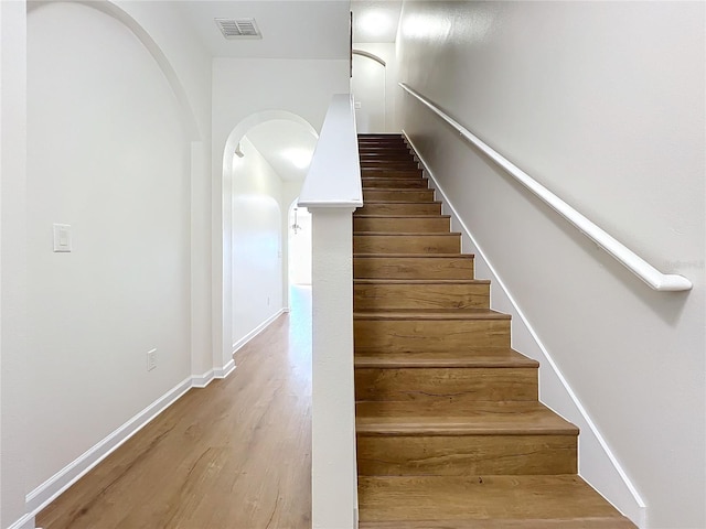 staircase featuring wood-type flooring