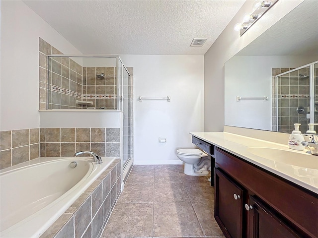 full bathroom with plus walk in shower, tile patterned flooring, vanity, toilet, and a textured ceiling