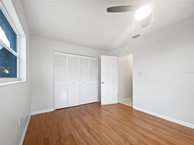 unfurnished bedroom featuring a closet, ceiling fan, and hardwood / wood-style flooring