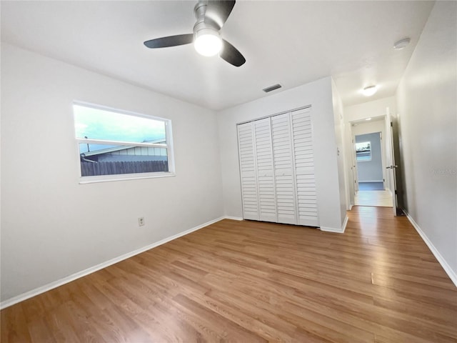 unfurnished bedroom featuring a closet, ceiling fan, and hardwood / wood-style flooring