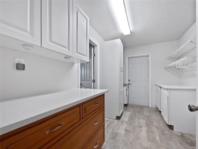 clothes washing area featuring light hardwood / wood-style flooring