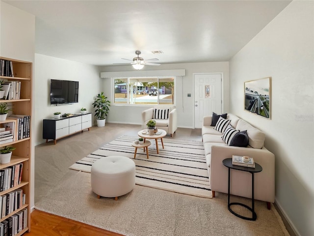 living room featuring carpet floors and ceiling fan