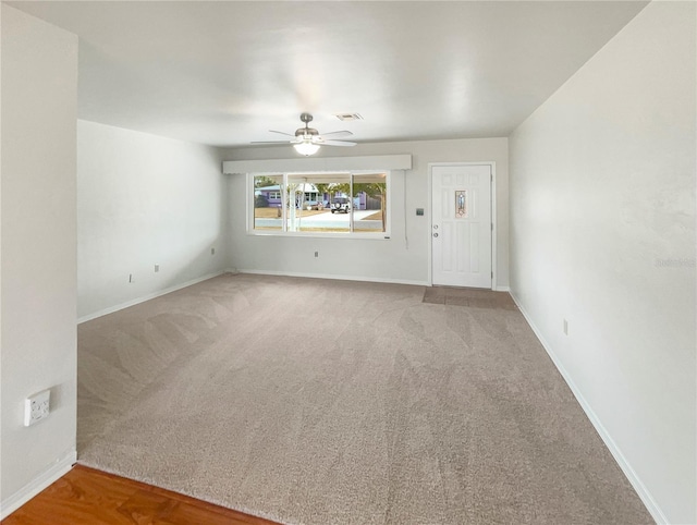 empty room featuring ceiling fan and carpet flooring