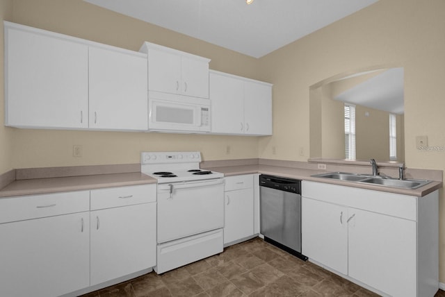 kitchen with sink, white cabinets, and white appliances