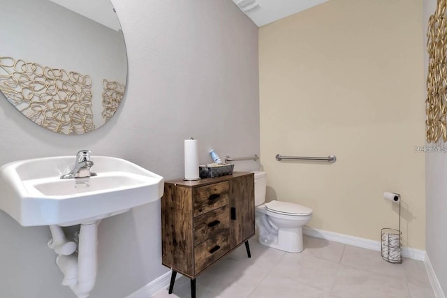 bathroom featuring toilet and tile patterned floors